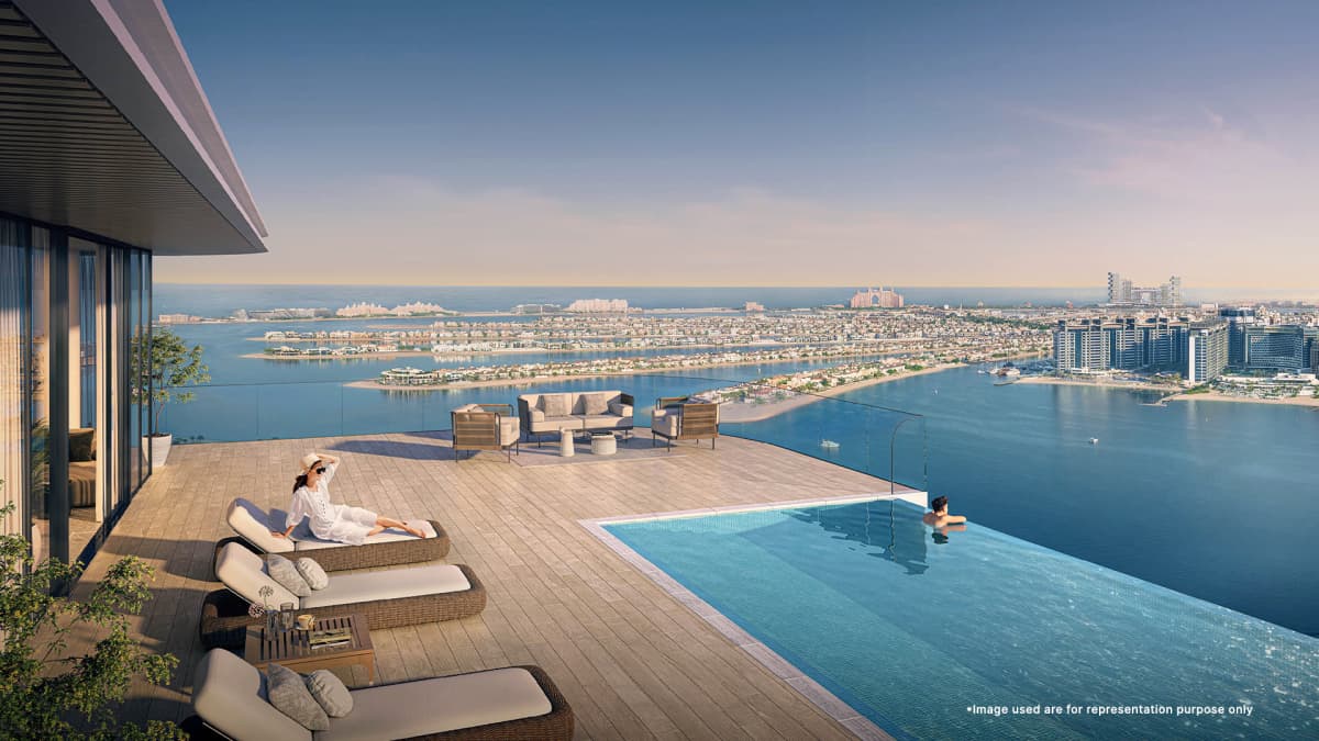 Couple is relaxing at Stunning rooftop pool of Seapoint At Emaar Beachfront with panoramic views of the Dubai skyline