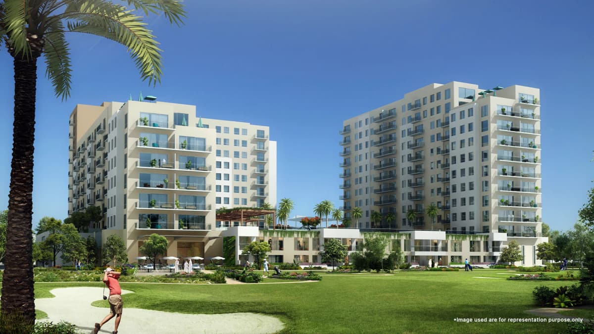 Lush Emaar Golf Views At Emaar South Golf Club with green fairways, surrounded by luxury residences and clear skies.