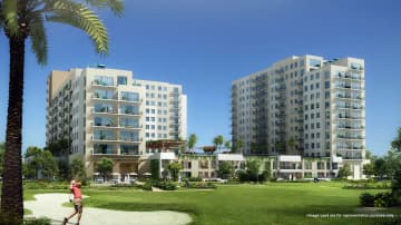 Lush Emaar Golf Views At Emaar South Golf Club with green fairways, surrounded by luxury residences and clear skies.